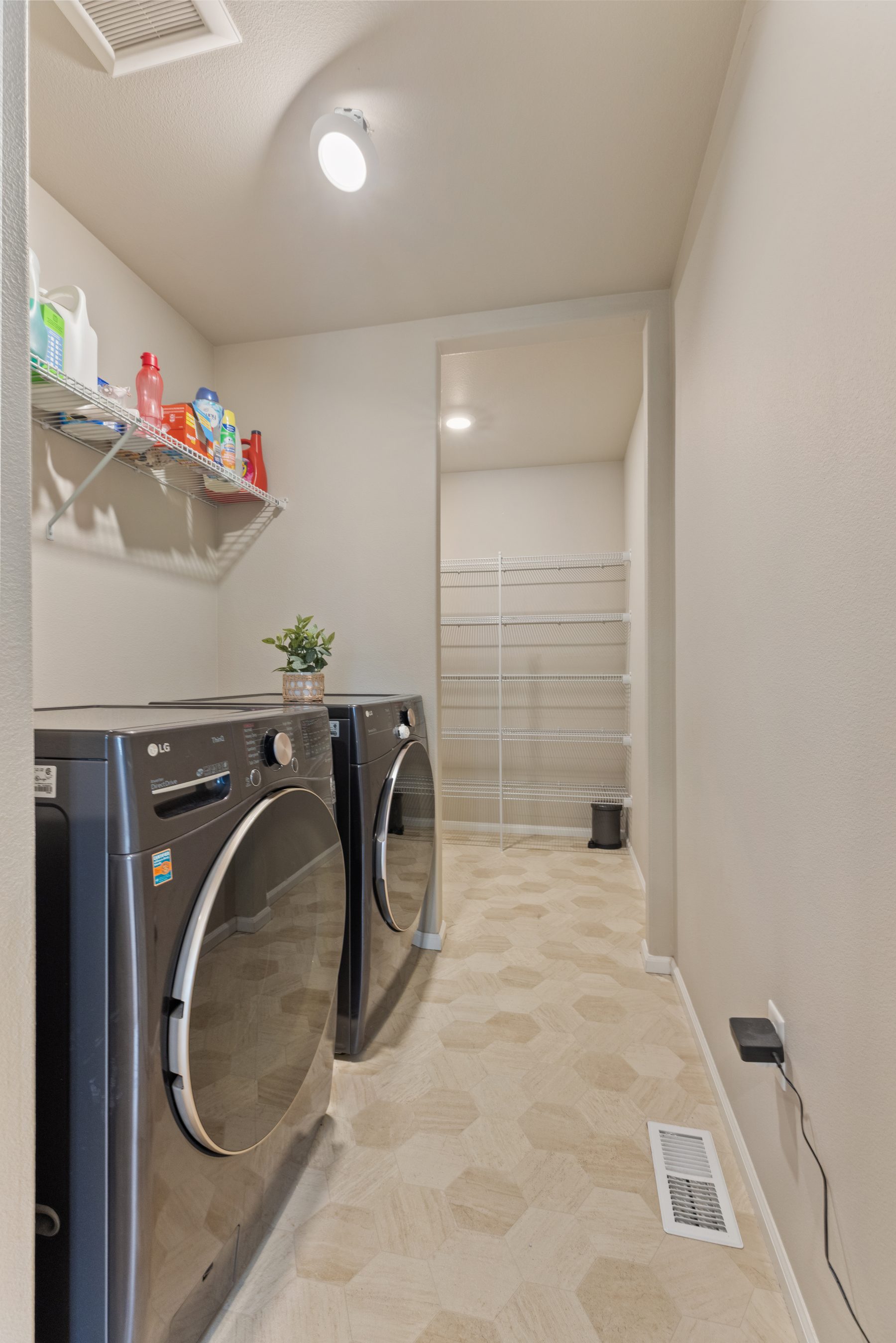 Oversized laundry room with linen closet