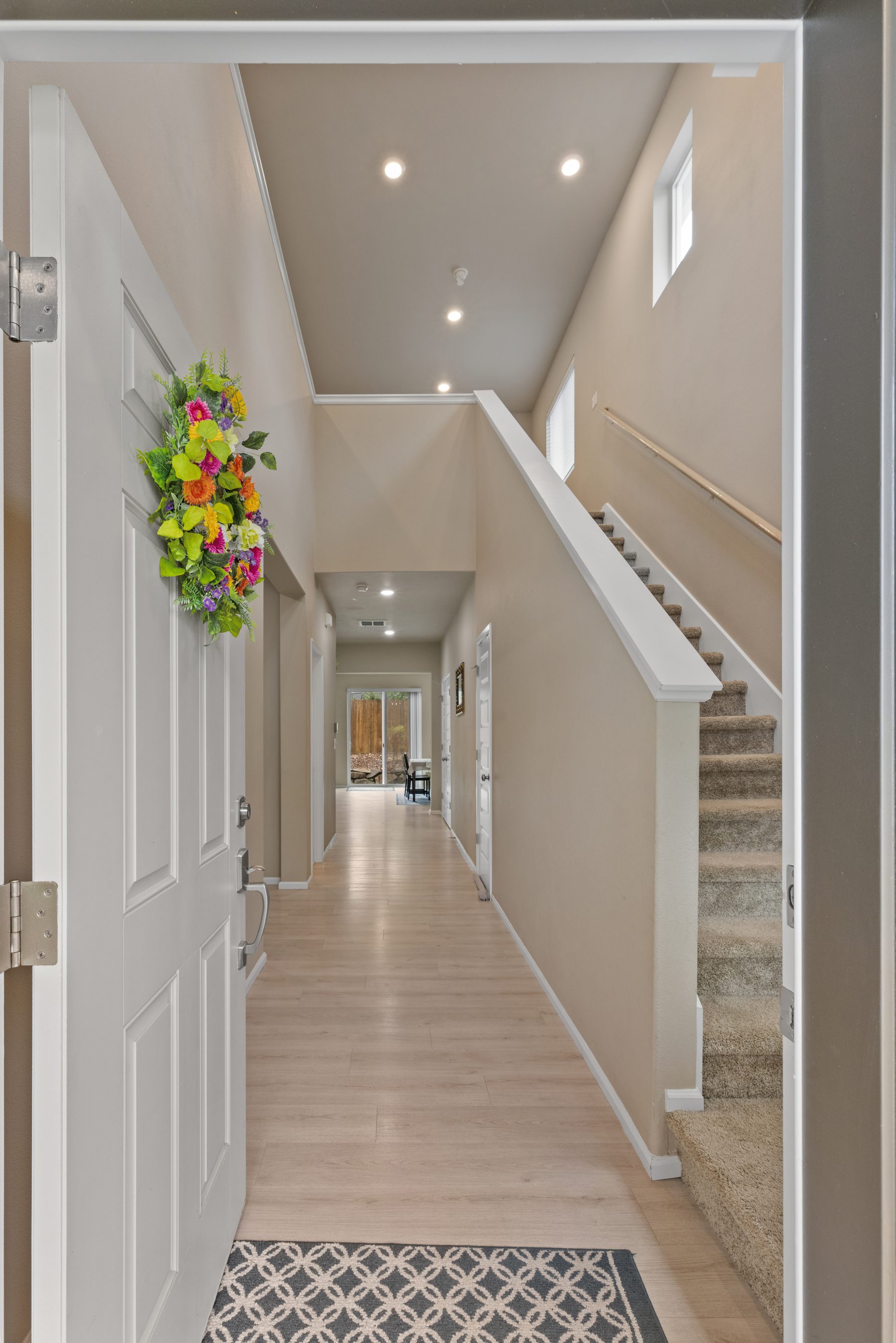 Foyer with vaulted entry and stairs