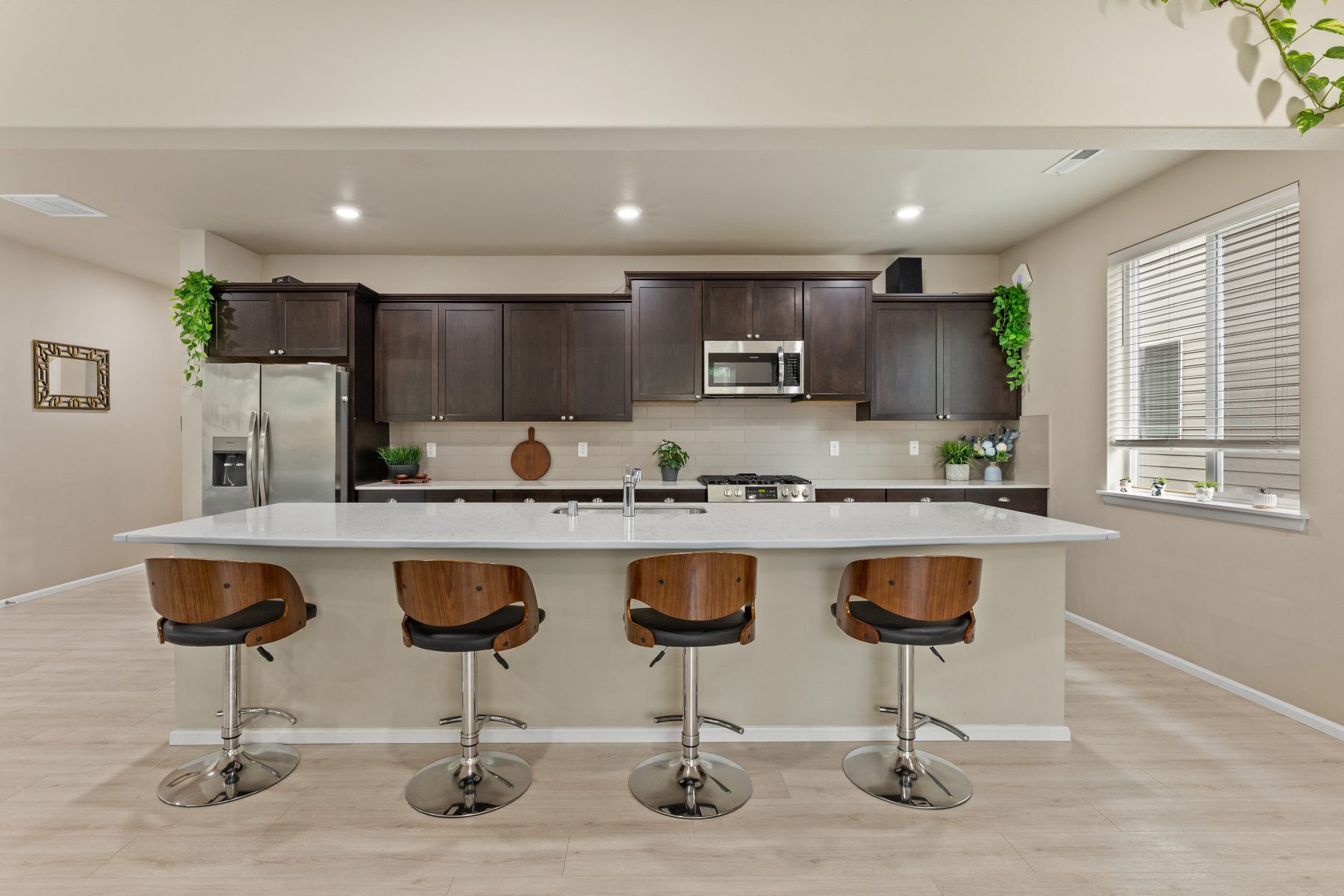 Kitchen with quartz island and gas range