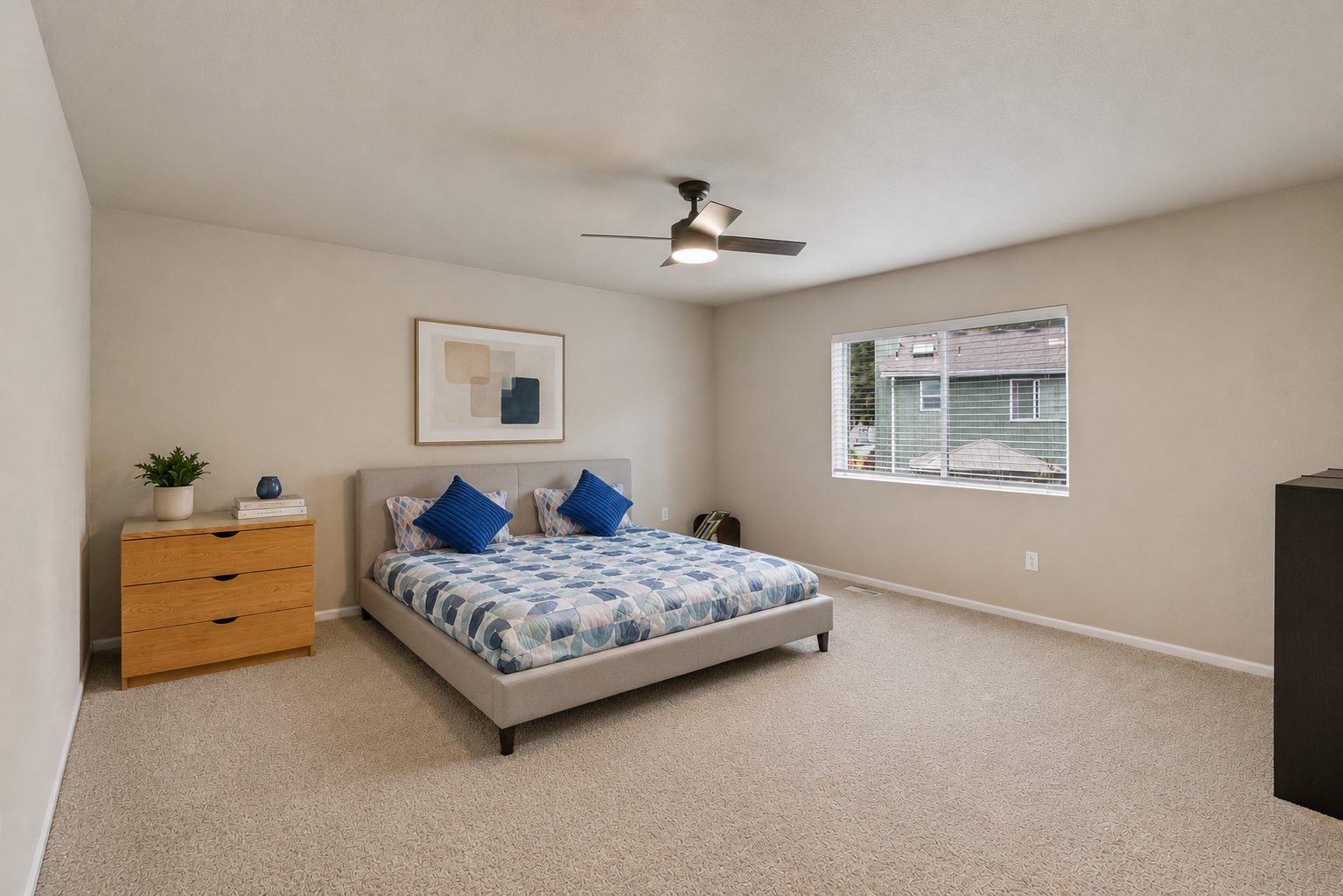 Primary bedroom with ceiling fan and oversized windows